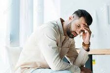 Handsome Upset Man Sitting And Touching Head In Office Stock Photo, Picture  And Royalty Free Image. Image 128157506.